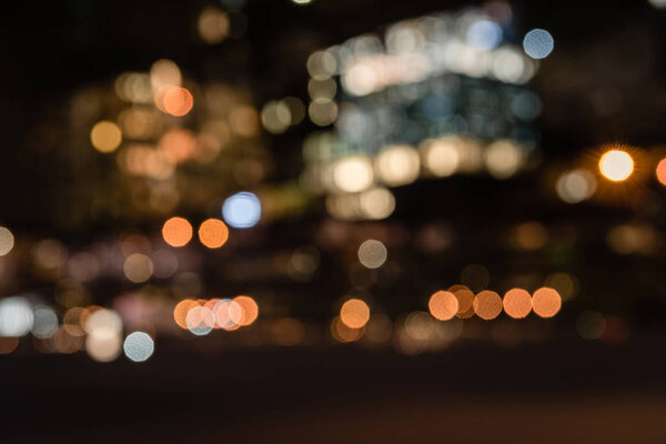 blurred buildings with bokeh lights at night