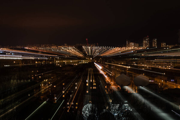 night cityscape with blurred bright illumination from windows