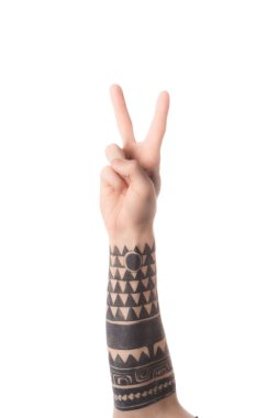 cropped view of tattooed man showing latin letter V in deaf and dumb language isolated on white
