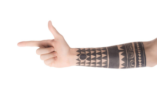 cropped view of tattooed man pointing left with finger isolated on white