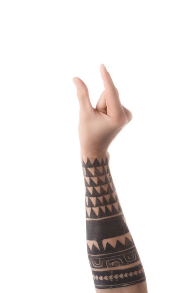 partial view of tattooed man showing size gesture with hand isolated on white
