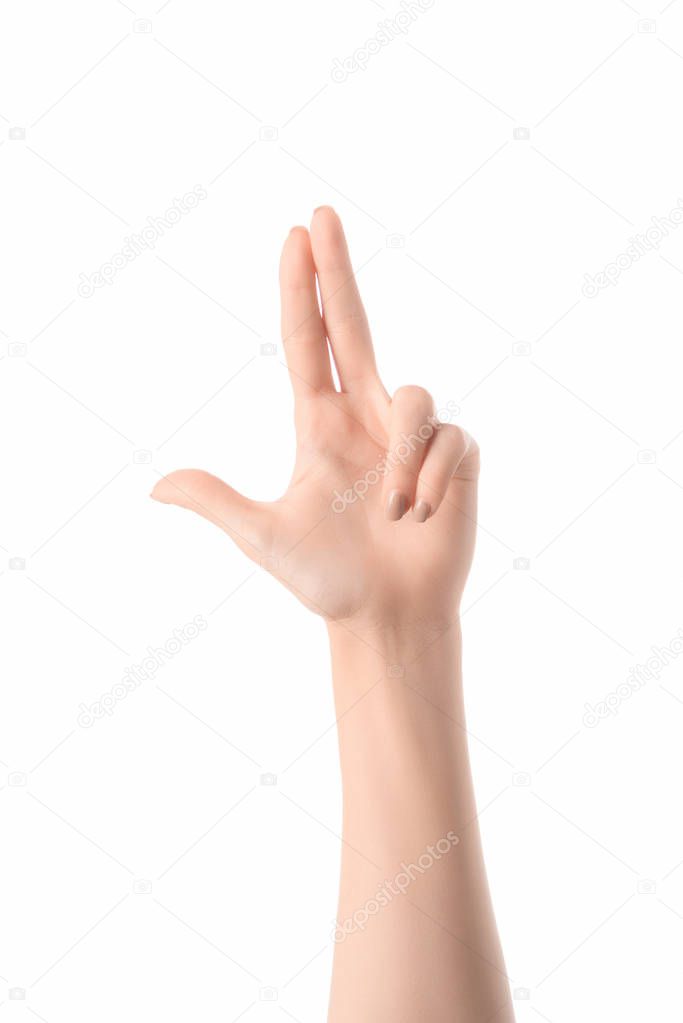 Partial view of woman making gun gesture with hands isolated on white