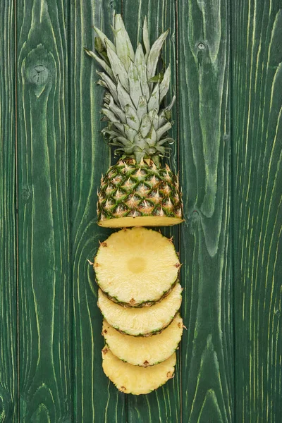 Yeşil Ahşap Masa Üzerine Dilimlenmiş Ananas Çevrelerin Üstten Görünüm — Stok fotoğraf