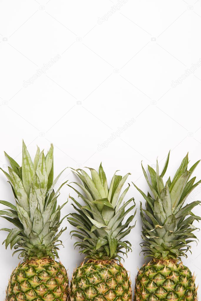 top view of organic fresh pineapples on white  background