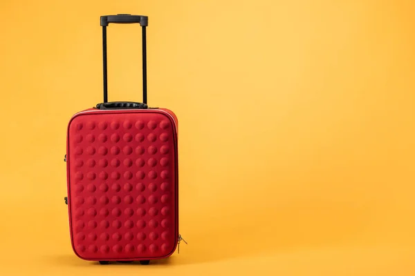 Red Travel Bag Wheels Handle Yellow Background — Stock Photo, Image