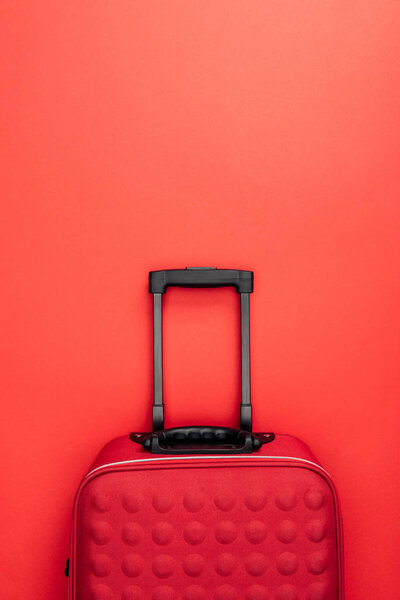 top view of travel bag with handle isolated on red