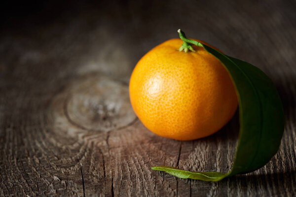 selective focus of organic tasty tangerine on wooden table 