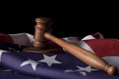 wooden gavel on american flag isolated on black clipart
