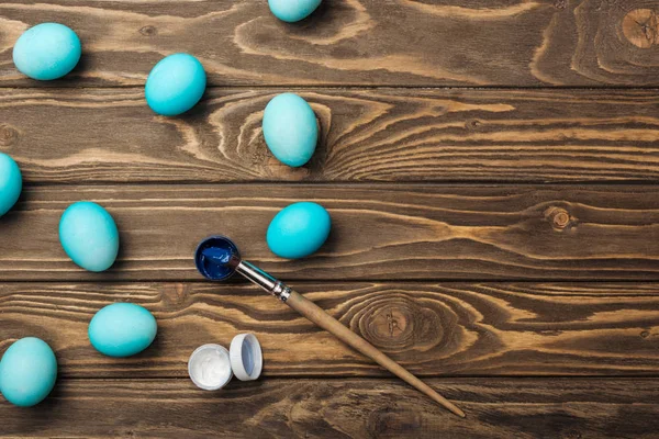 Top View Pastel Blue Easter Eggs Paints Paintbrush Wooden Surface — Stock Photo, Image