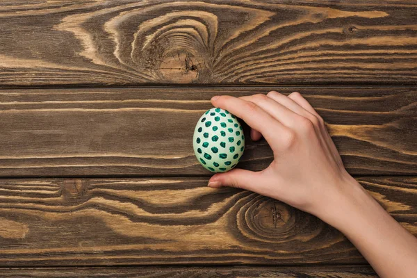 Top View Woman Holding Easter Egg Pattern Wooden Surface — Stock Photo, Image