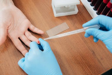 cropped view of donor and doctor obtaining blood sample clipart