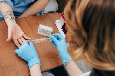 cropped view of donor and doctor obtaining blood sample clipart