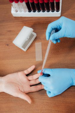 cropped view of donor and doctor obtaining blood sample clipart