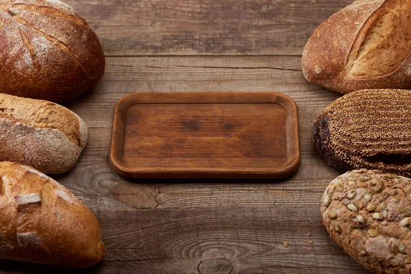 Delicious Loaves Bread Empty Board Wooden Table — Stock Photo, Image