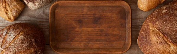 Panoramatický Výprk Dřevěné Sekací Desky Mezi Chlebem — Stock fotografie