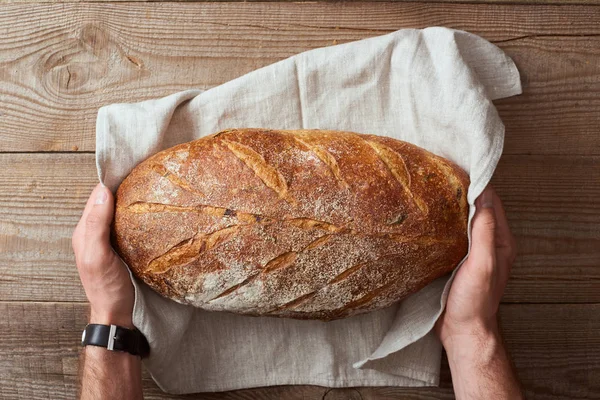 Top View Man Holding Fresh Homemade Bread White Towel Wooden — Stock Photo, Image