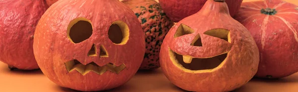 Assustador Esculpido Halloween Abóboras Fundo Laranja Tiro Panorâmico — Fotografia de Stock