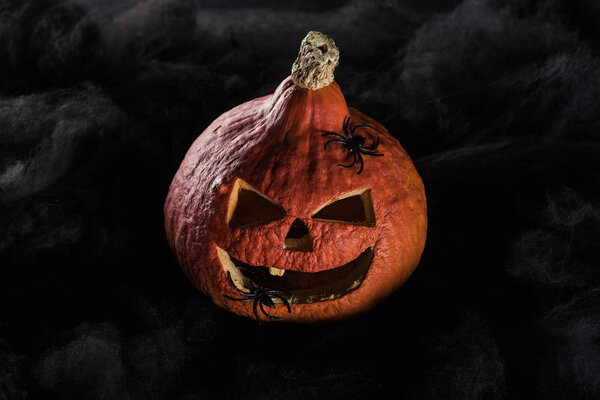 spooky carved Halloween pumpkin on black background