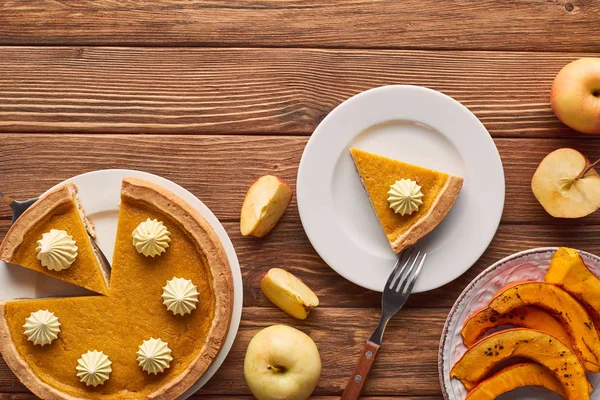 Leckerer Geschnittener Kürbiskuchen Mit Schlagsahne Neben Gebackenem Kürbis Gabel Ganzen — Stockfoto