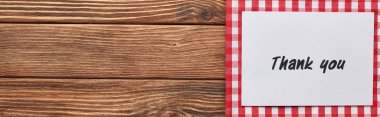 top view of thank you card on wooden brown table with red plaid napkin, panoramic shot clipart