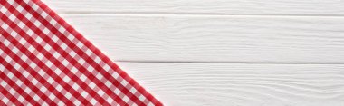 top view of checkered red napkin at white wooden table, panoramic shot clipart