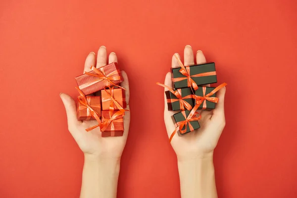 Partial View Woman Holding Decorative Gift Boxes Red Background — Stock Photo, Image