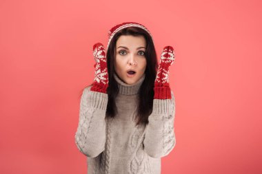shocked woman in knitted hat and gloves on pink  clipart