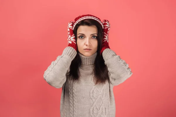 Attractive woman in knitted hat and gloves covering ears on pink — Stock Image Attractive Woman Knitted Hat Gloves Covering Ears Pink Stock Photo