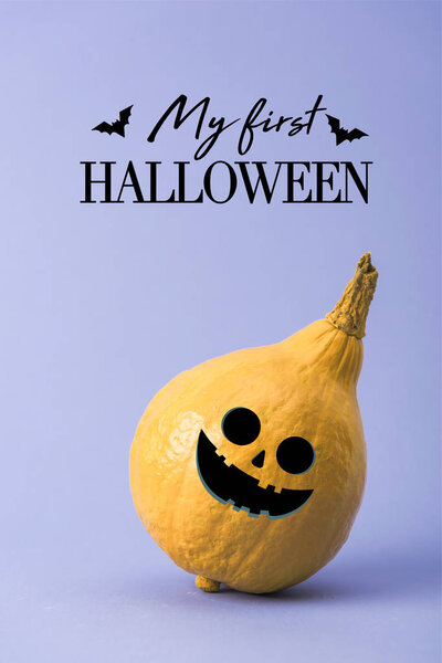 yellow colorful painted pumpkin on violet background with my first Halloween illustration