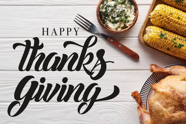 верхний вид индейки и кукурузы подается за белым деревянным столом с счастливой иллюстрацией благодарения
