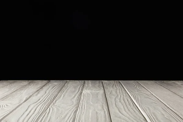 White grungy wooden table on black — Stock Photo