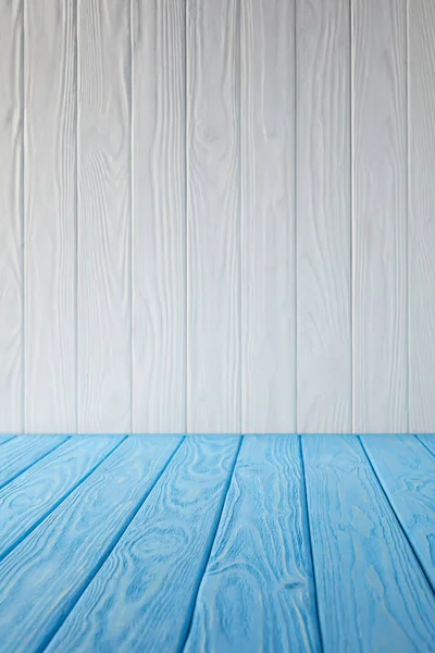 Blue striped tabletop and white wooden wall — Stock Photo