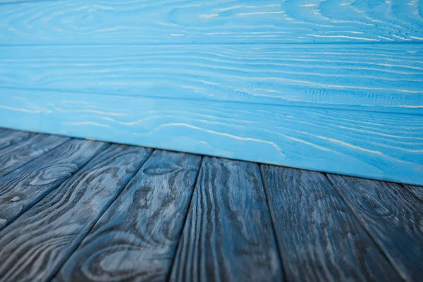 Dark blue grungy wooden floor and light blue wooden wall — Stock Photo