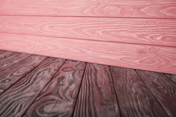 Grey wooden floor and pink striped wooden wall — Stock Photo