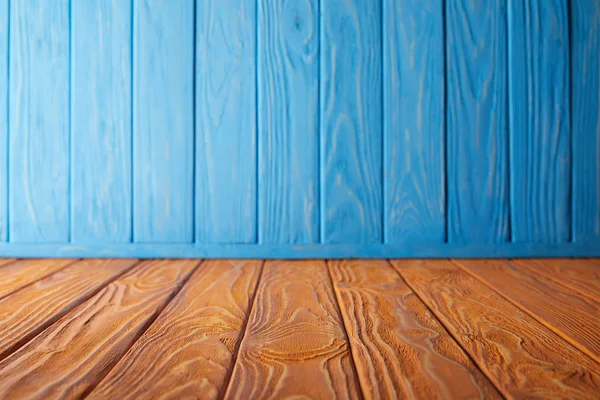Brown striped tabletop and blue wooden wall — Stock Photo