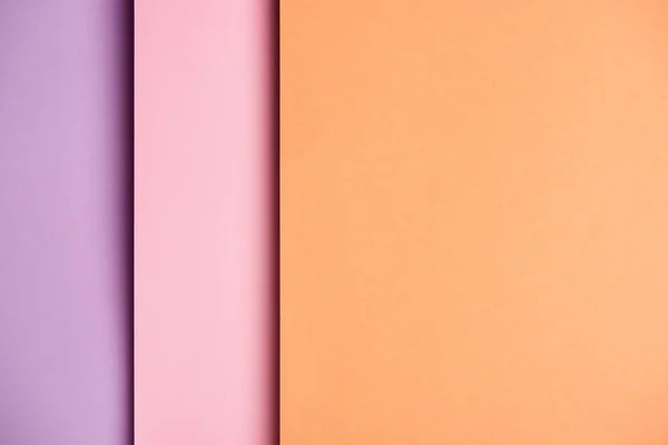 Paper sheets in pink and orange tones background — Stock Photo