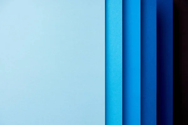 Pattern of vertical overlapping paper sheets in blue  tones — Stock Photo