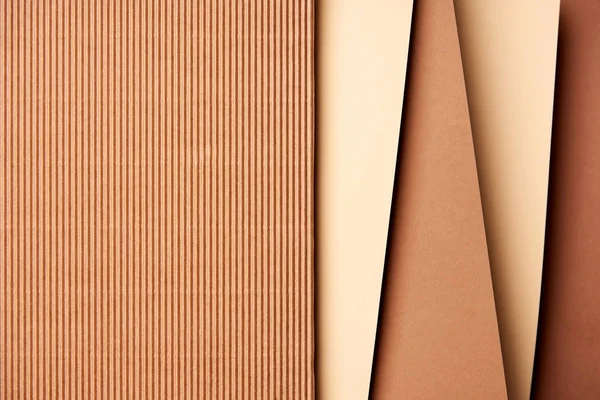 Paper sheets in beige and brown tones background — Stock Photo