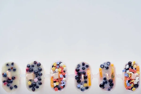 Top view of cold homemade ice cream with fruits and berries on grey background — Stock Photo