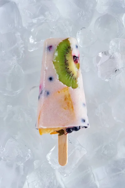 Top view of delicious homemade ice cream with fruits and berries on ice cubes — Stock Photo