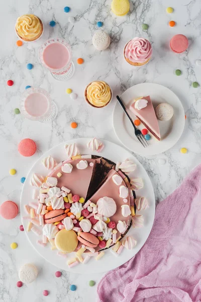 Flat lay with birthday cake, marshmallows, candies, sweet cupcakes and milkshakes — Stock Photo