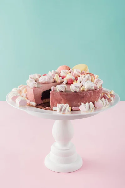 Sweet cake with marshmallows and macarons on cake stand — Stock Photo