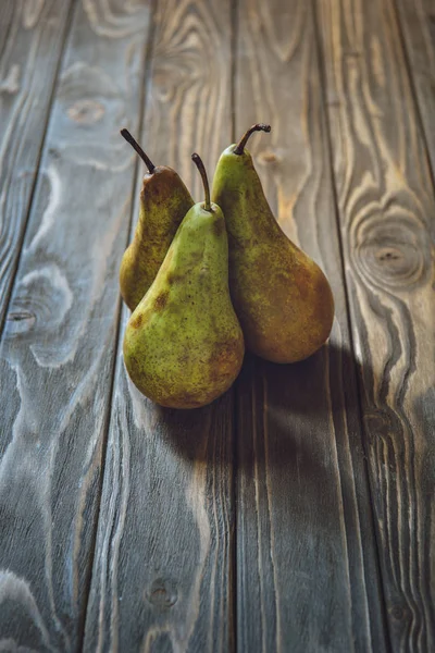 Gros plan d'un bouquet de poires fraîches sur une table rustique en bois — Photo de stock