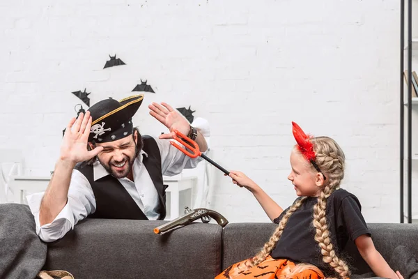 Portrait of daughter and father in halloween costumes playing at home — Stock Photo