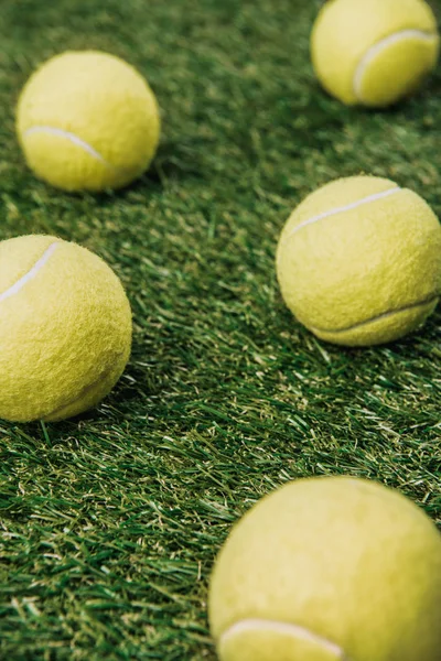 Close up view of tennis balls on green lawn — Stock Photo