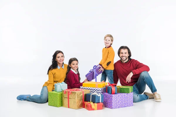 Happy family with wrapped presents isolated on white — Stock Photo