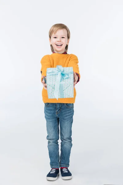 Happy boy with gift box looking at camera isolated on white — Stock Photo