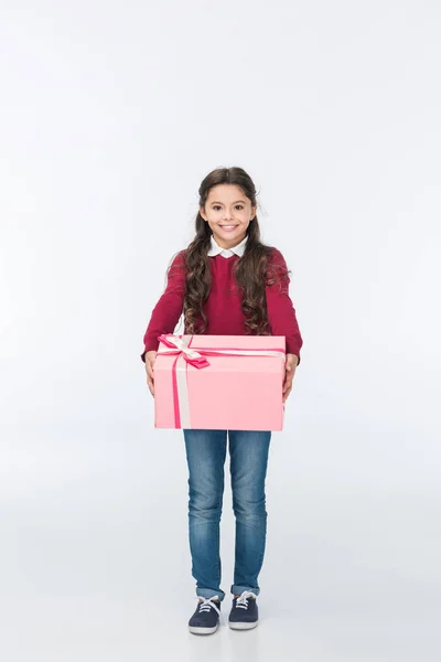 Smiling child with pink present looking at camera isolated on white — Stock Photo