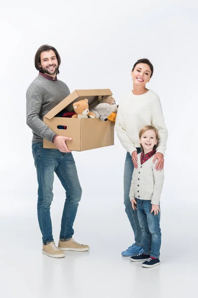 Happy father holding cardboard box with toys and looking at camera isolated on white — Stock Photo