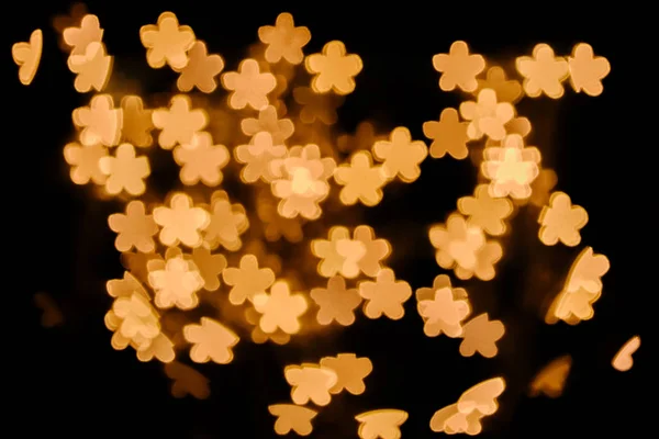 Voller Rahmen aus goldenen Sternen Bokeh Lichter auf schwarzem Hintergrund — Stockfoto